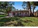 Charming single-story home with an attached garage, a well-maintained lawn and mature trees at 1830 Virginia Dr, Bradenton, FL 34205