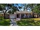 Charming single-story home with a well-maintained lawn, a garage and a welcoming front porch at 1830 Virginia Dr, Bradenton, FL 34205