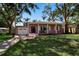 Charming single-story home with a well-maintained lawn, a garage and a welcoming front porch at 1830 Virginia Dr, Bradenton, FL 34205