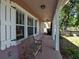 Inviting front porch featuring a wooden bench and white columns offering a relaxing outdoor space at 1830 Virginia Dr, Bradenton, FL 34205