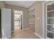 Hallway that connects to kitchen features tile flooring and access to a doorway and other rooms at 1830 Virginia Dr, Bradenton, FL 34205