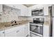 Clean kitchen with granite countertops and stainless steel appliances at 1830 Virginia Dr, Bradenton, FL 34205