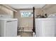 Laundry room features a window and washer dryer hook-ups plus shelving for storage at 1830 Virginia Dr, Bradenton, FL 34205