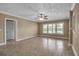 Open living room with large windows that allow in natural light, enhancing the tiled floor and ceiling fan at 1830 Virginia Dr, Bradenton, FL 34205