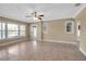 Bright living room with tiled floors, large windows, and a ceiling fan at 1830 Virginia Dr, Bradenton, FL 34205