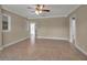 Sunlit living room featuring neutral walls, tile flooring, and multiple windows for ample natural light at 1830 Virginia Dr, Bradenton, FL 34205