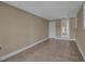 Neutral living room featuring tile floors, white trim, and two doorways that brighten the space at 1830 Virginia Dr, Bradenton, FL 34205