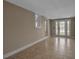 Tiled living space with neutral walls and french doors leading outside at 1830 Virginia Dr, Bradenton, FL 34205