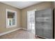 Mud room with tile flooring and a large storage cabinet features a window and exterior access at 1830 Virginia Dr, Bradenton, FL 34205