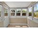 Bright sunroom features tile floors and multiple windows for natural light and views of the backyard at 1830 Virginia Dr, Bradenton, FL 34205