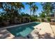 Beautiful backyard swimming pool surrounded by lush landscaping and a spacious patio area perfect for relaxation at 1830 Virginia Dr, Bradenton, FL 34205