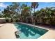 Inviting swimming pool with an ample patio area and privacy-enhancing landscaping creates a backyard oasis at 1830 Virginia Dr, Bradenton, FL 34205