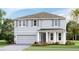 Charming two-story home featuring a two-car garage, and a welcoming front porch at 18305 Fattoria Ter, Lakewood Ranch, FL 34211
