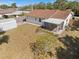 An aerial of a backyard with a screened-in porch and a storage shed; a mix of grassy and bare patches at 1856 Wharf Rd, Sarasota, FL 34231