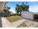 Spacious backyard featuring a storage shed and concrete patio with a wooden fence for privacy at 1856 Wharf Rd, Sarasota, FL 34231