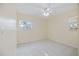 Bright bedroom with two windows, neutral paint, and tile flooring creates a serene atmosphere at 1856 Wharf Rd, Sarasota, FL 34231