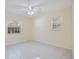 Comfortable bedroom with tile flooring, natural light from two windows, and neutral wall color at 1856 Wharf Rd, Sarasota, FL 34231