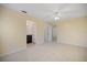 Bright bedroom with tile flooring, ceiling fan, and doorway that leads to a bathroom at 1856 Wharf Rd, Sarasota, FL 34231