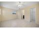 Comfortable bedroom with tile flooring, ceiling fan, and doorway that leads to a bathroom at 1856 Wharf Rd, Sarasota, FL 34231