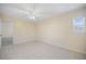 Bedroom features include tile flooring, ceiling fan, and a window for natural lighting at 1856 Wharf Rd, Sarasota, FL 34231
