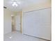 Bedroom featuring a ceiling fan, closet, and doorway, offering a cozy and functional space at 1856 Wharf Rd, Sarasota, FL 34231