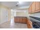 Spacious kitchen featuring wood cabinets, black countertops, and an open view to a living area at 1856 Wharf Rd, Sarasota, FL 34231