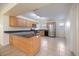 Well-lit kitchen with wood cabinets, black countertops, stainless steel appliances and tiled flooring at 1856 Wharf Rd, Sarasota, FL 34231