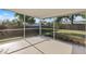 Inviting screened porch overlooking a well-maintained backyard with lush greenery and a shed at 1856 Wharf Rd, Sarasota, FL 34231