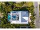 An aerial shot shows a property with a pool, outdoor seating area, and lush green surroundings at 212 72Nd, Holmes Beach, FL 34217