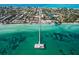 Expansive aerial view of a coastal neighborhood, pier, and turquoise ocean waters at 212 72Nd, Holmes Beach, FL 34217