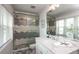Bathroom featuring a walk-in shower, white vanity with sink, and a nautical decor at 212 72Nd, Holmes Beach, FL 34217