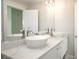 Bathroom with white cabinets, marble counters, large mirror, and modern vessel sinks at 212 72Nd, Holmes Beach, FL 34217