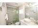 This bathroom features a glass-enclosed shower, white vanity with sink, and a decorative dolphin mounted on the wall at 212 72Nd, Holmes Beach, FL 34217