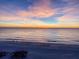 Scenic beach view with vibrant sunrise or sunset and calm ocean waters at 212 72Nd, Holmes Beach, FL 34217