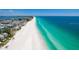 Panoramic aerial view of a pristine white sandy beach meeting the clear turquoise ocean at 212 72Nd, Holmes Beach, FL 34217
