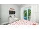 Bedroom featuring access to a balcony, light colored dresser, and coastal themed wall decor at 212 72Nd, Holmes Beach, FL 34217