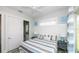 Cozy bedroom featuring an ensuite bathroom, coastal decor, and natural light at 212 72Nd, Holmes Beach, FL 34217