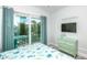 Bedroom featuring access to a balcony, green dresser, and decorative beach themed wall decor at 212 72Nd, Holmes Beach, FL 34217