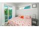 Bedroom featuring access to a balcony, coastal decor, and natural light at 212 72Nd, Holmes Beach, FL 34217