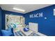 Bright, beachy living room with comfortable furniture, white wicker chairs, and access to outdoor area at 212 72Nd, Holmes Beach, FL 34217