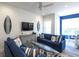 Bright living room featuring nautical decor, comfortable sofas, and large windows for natural light at 212 72Nd, Holmes Beach, FL 34217