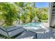 Backyard with a beautifully designed pool, a raised spa, and a spacious deck perfect for relaxation and entertainment at 212 72Nd, Holmes Beach, FL 34217