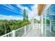 This deck features a spiral staircase, providing access to the roof and offering views of the lush surroundings at 212 72Nd, Holmes Beach, FL 34217