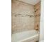 Relaxing bathroom featuring a soaking tub with decorative tile accents at 2300 Stratford Dr, Sarasota, FL 34232