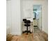 Entry showing a vanity with chair, mirror, and view into the bathroom at 2300 Stratford Dr, Sarasota, FL 34232