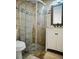 Bathroom features a vanity with wood mirror and modern shower with pebble base at 2300 Stratford Dr, Sarasota, FL 34232