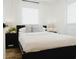 Bright bedroom features a bed with white bedding, decorative pillows and views from the windows at 2300 Stratford Dr, Sarasota, FL 34232