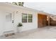 Charming home exterior with white walls, stylish lattice and a welcoming front entrance at 2300 Stratford Dr, Sarasota, FL 34232