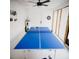 Game room featuring a ping pong table, dart board, and ceiling fan, perfect for Gathering fun at 2300 Stratford Dr, Sarasota, FL 34232