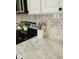 Close-up of granite kitchen countertops with decor, stainless steel stove, and stylish backsplash at 2300 Stratford Dr, Sarasota, FL 34232